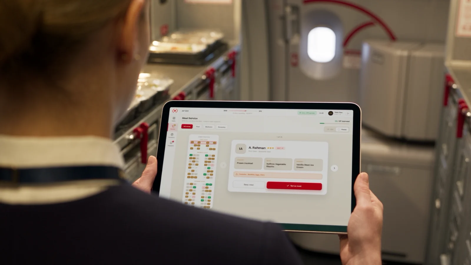 A crew member using ANiX on a galley tablet